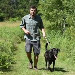 Man hiking with dog in Rusk County WI